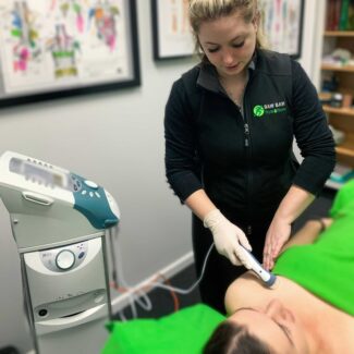 This image shows our Myotherapist, Kaleisha conducting a Mastitis treatment using our ultrasound machine.